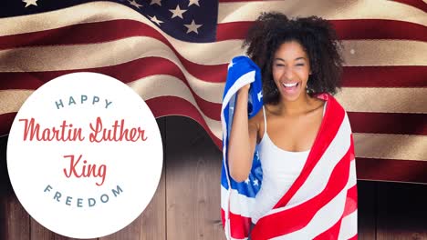 Animation-of-happy-martin-luther-king-day-text-over-happy-african-american-woman-with-american-flag