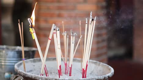 incense sticks burning in a pot