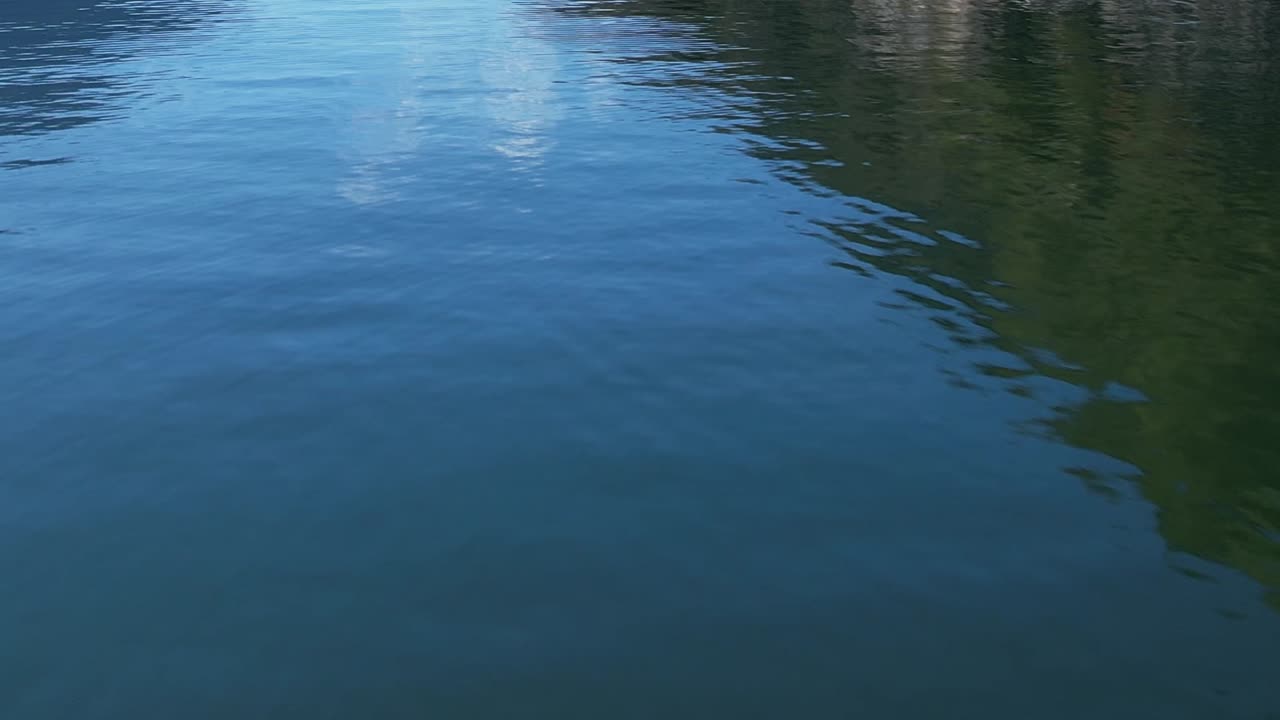 Stunning aerial view of clear blue lake in the Italian Alps during daylight