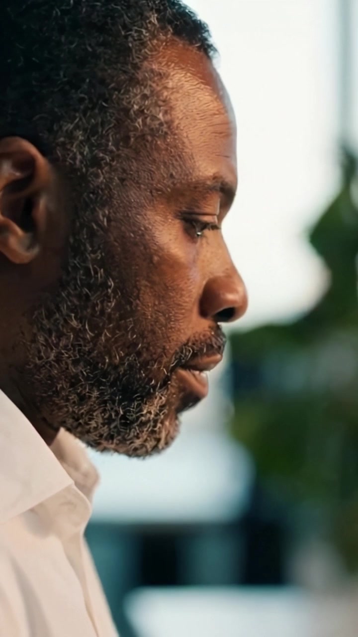 A Thoughtful Moment: A Close-Up View of a Man in Profile Reflecting on Life and Decisions in an Inviting Environment Filled with Soft Natural Light