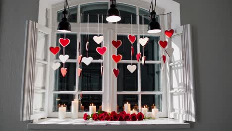 romantic window decor with hearts and candles