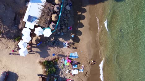 hippie bar with umbrellas on nudist beach