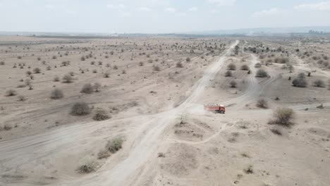 a truck drives through the dusty sand roads of the african landscape