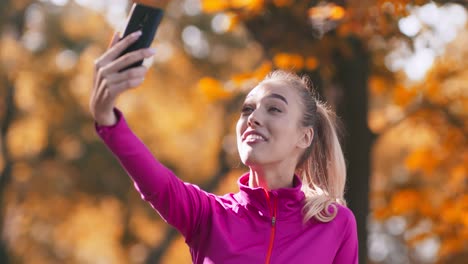 woman taking a selfie in an autumn park