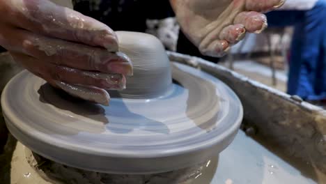 overhead close view of an african american hands spinning clay very sporadically