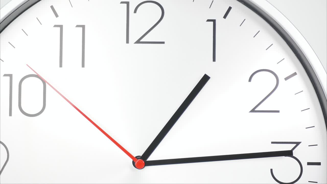 White wall clock shows the running of time.