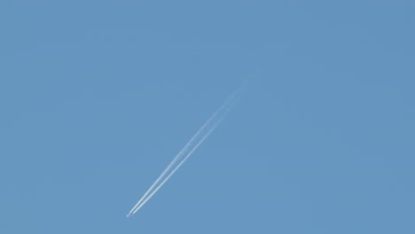 aeroplane with contrails clear blue sky australia, victoria, gippsland, maffra daytime wide shot