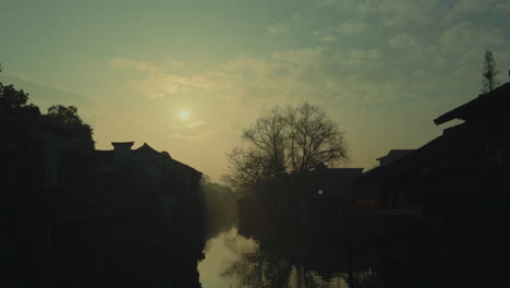 morning light over wuzhen, china, highlighting traditional houses and calm waters