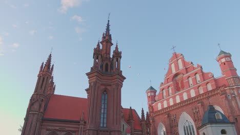 may 29, 2022: vilnius, lithuania. roman catholic church of st. anne and church of st. francis and st. bernard in old town in summer sunny day. unesco world heritage