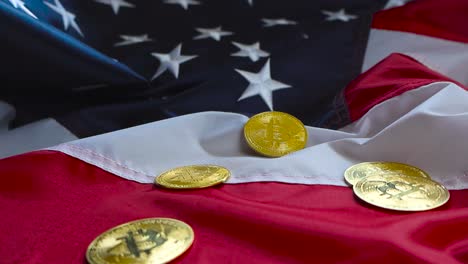 gorgeous close up or closeup video of golden shiny and reflective bitcoin coins on an american us flag while the footage orbits around the cryptocurrency money. background is in bokeh blurry focus.