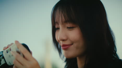woman taking a video with a camera outdoors