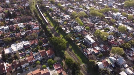 Red-train-crossing-residential-neighborhood-at-Buenos-Aires