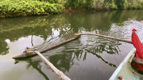 Wooden-fishing-boat-with-oars-floating-in-Saleri-River-Goa-India-4K