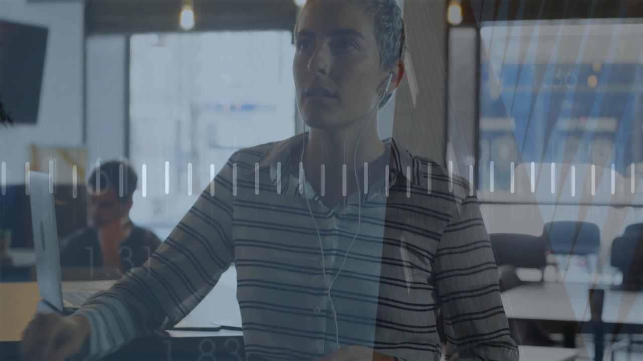 Animation of graph, heart rhythm over caucasian woman holding cellphone talking with coworker