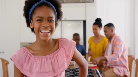 Front-view-of-happy-black-girl-looking-at-camera-in-a-comfortable-home-4k