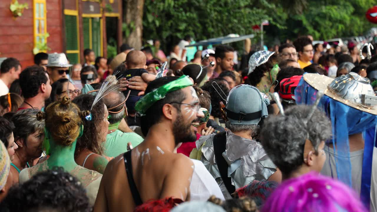 group of people with carnival costume dancing and celebrating on the street