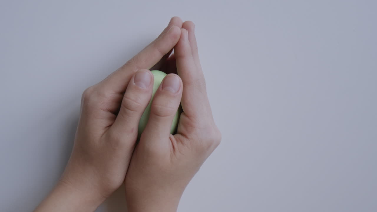 Green Easter Egg Held in Hands