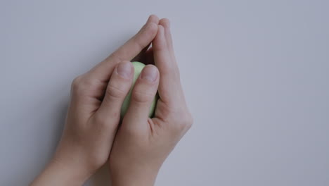 green easter egg held in hands