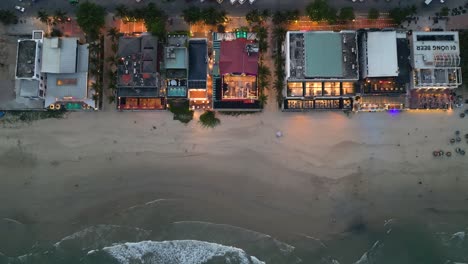 aerial view of beachfront restaurants and hotels at night in danang, vietnam.