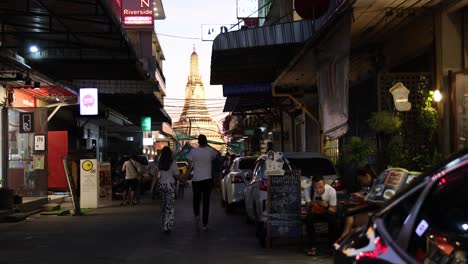 people walking through a busy market street