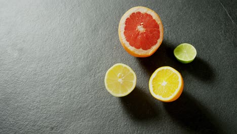 Halved-citrus-fruit-on-grey-background-4k