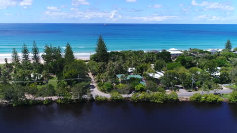 river meets the ocean with stunning contrast with houses