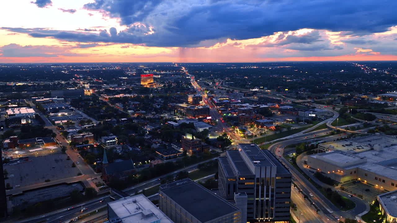Vast panorama of Detroit in the evening. Dramatic cloudscape with rain at the horizon in the sky over the city. Aerial view