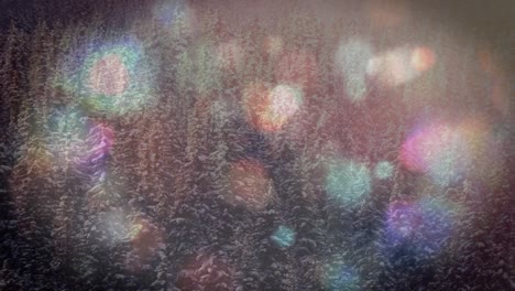 animation of multiple flickering spots of light over winter scenery in forest