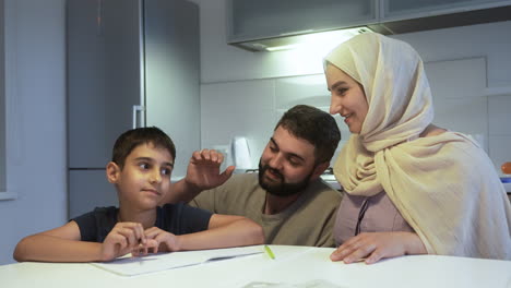 mother, father and son in the kitchen