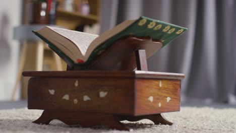 close up of open copy of the quran on stand at home 4