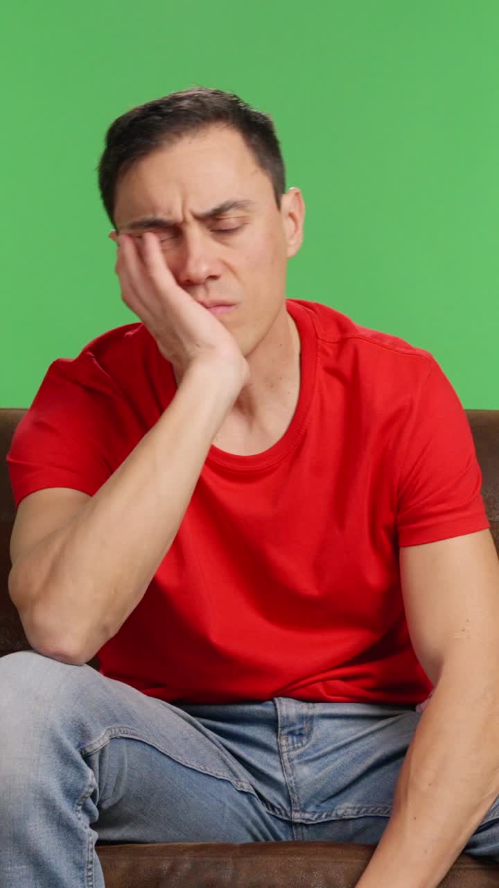 Sad and depressed man trying to watch a movie