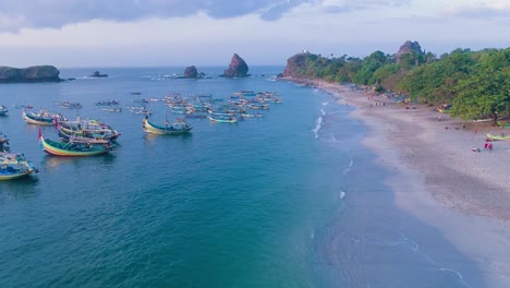 indonesia traditional fishing boats docked in shores after fishing an aerial view, papuma beach jember