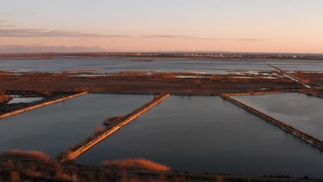 aerial - beautiful sunrise in the solana ulcinj salt flats, montenegro, forward