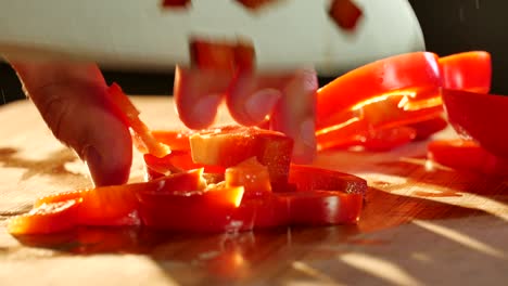 cutting red bell pepper with knife