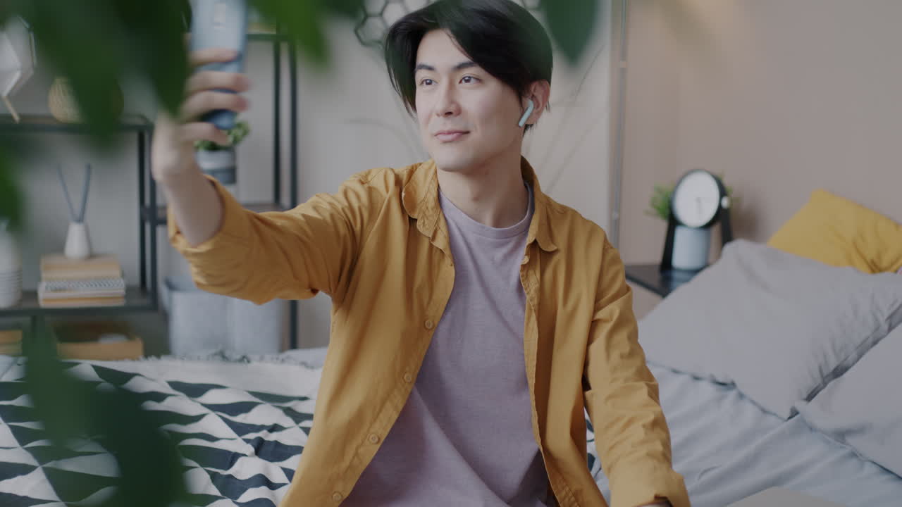 Young Man Having a Video Call in His Bedroom