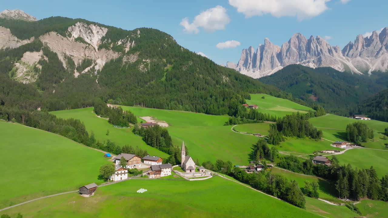 Slow panning drone shot of St Magdalena church in Val di Funes valley, Dolomites, Italy