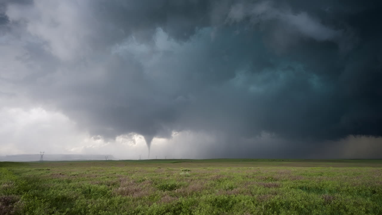 Mesmerizing Tornado Touches Down Near Power Lines On The Open Plains