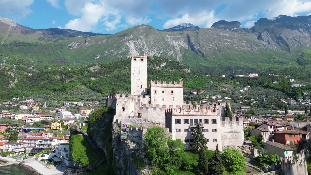 Aerial view of Castello Scaligero perched on a cliff above Lake Garda in Malcesine. Malcesine, Italy