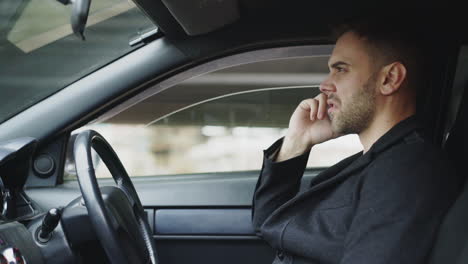 man talking on phone in a car