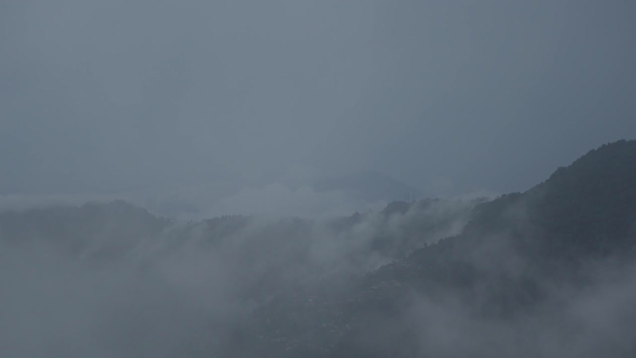The mountain is covered in clouds during the rainy season