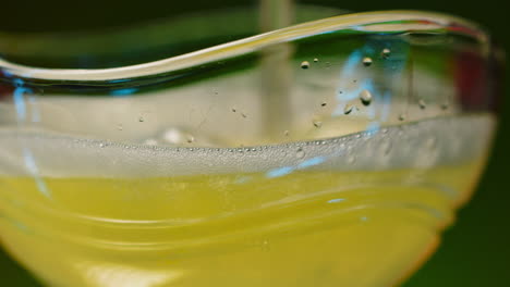 close-up of a yellow beverage in a glass bowl