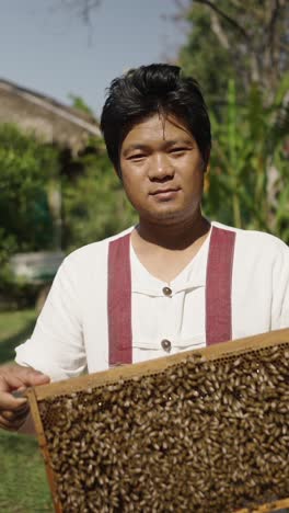 beekeeper with honeycomb