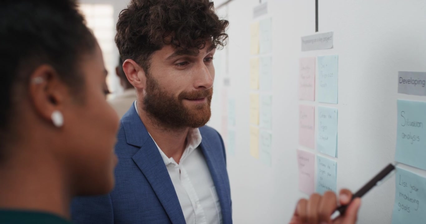 Business Colleagues Collaborating on Project Strategy Using Sticky Notes