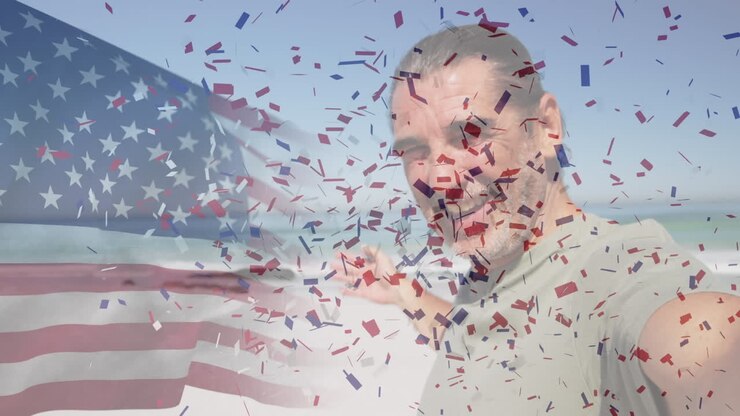 Animation of american flag waving and confetti falling over smiling senior man on the beach