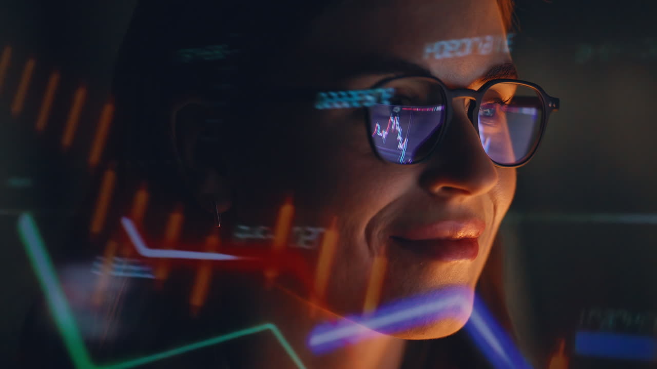 Late trader studying graphs wearing glasses watching laptop display closeup