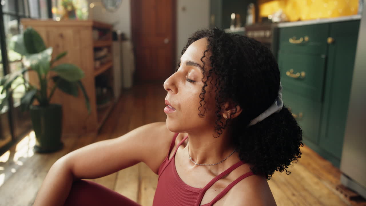 Young Woman Meditating and Opening Eyes on Yoga Mat
