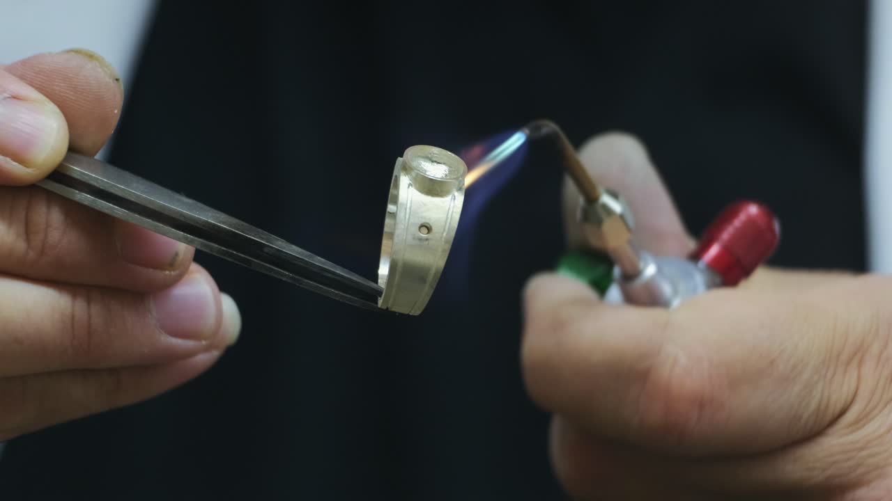 Processing gold rings with jewels flame torch