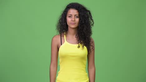 young beautiful hispanic woman giving thumbs up