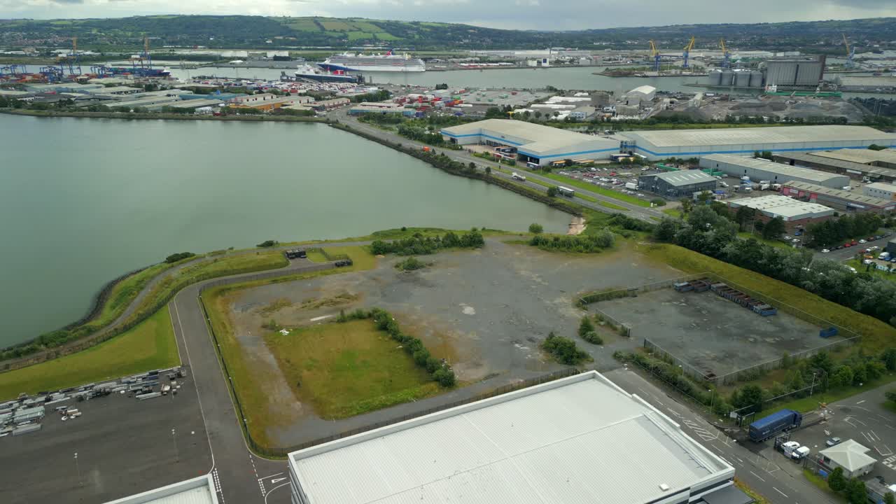 Wide advancing aerial video GV of Studio Ulster, a virtual production film studio in Belfast, Northern Ireland, UK. Filmed in 60FPS, 4K and with Rec709 color
