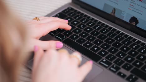 over-the-shoulder-of-the-hands-of-a-beautiful-woman-browsing-her-notebook